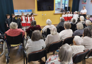 Dzieci śpiewają piosenkę dla pensjonariuszy